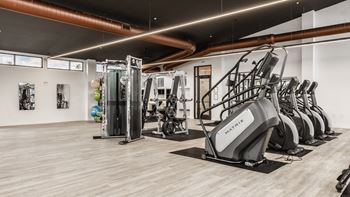 Spacious fitness center with cardio machines and weights